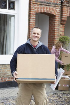 Man with van loading furniture in Brixton street setting