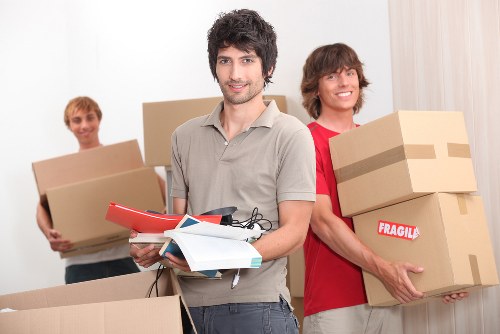 Professional movers handling a flat move in Brixton with careful loading